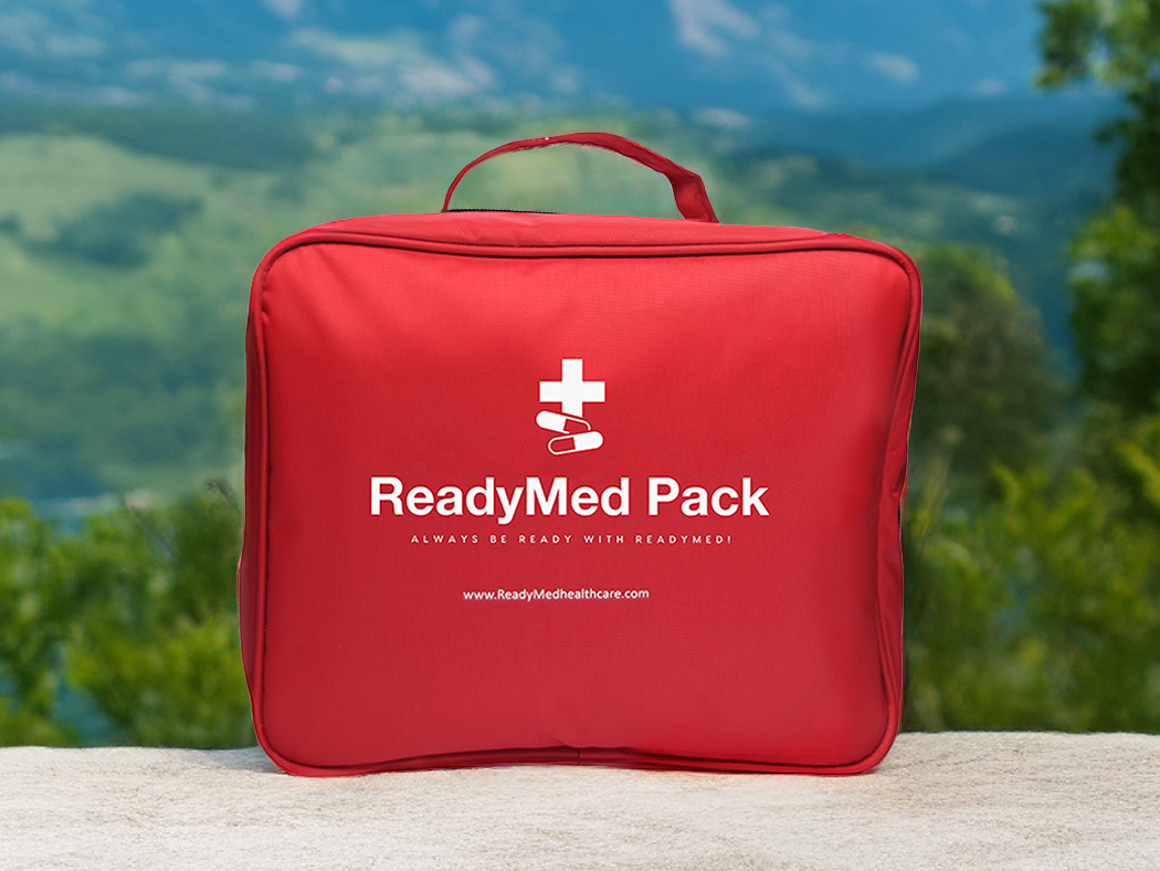 ReadyMed Ultimate Pack in front of a mountainous view.